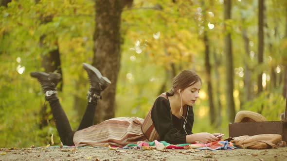Young Woman in Autumn Outdoor. Sensual Outdoor Portrait of Young Stylish Fashion Girl in Autumn