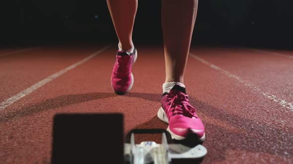 Close-up Legs in Sneakers Athletes Are Running Pads on the Track of the Sports Complex and Run in