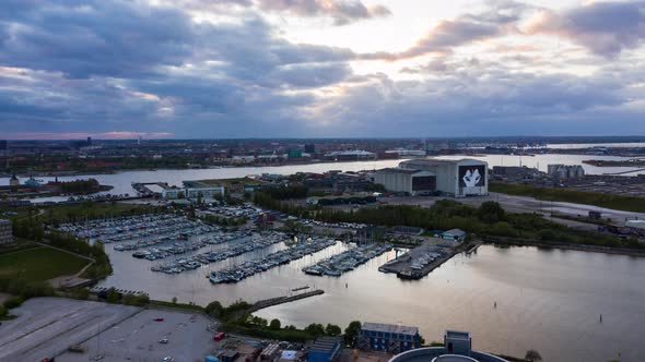 Harbor in Copenhagen with Boats Docked and Clouds in the Sky at Dawn