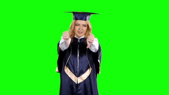 Frustrated Graduate Shows Two Thumbs Down. Green Screen