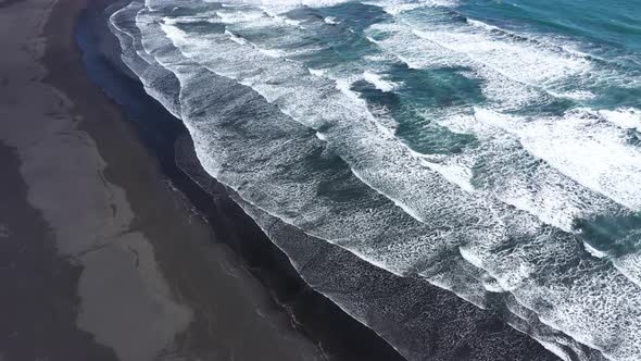 Atlantic Ocean Waves Washing Black Sandy Beach in Iceland