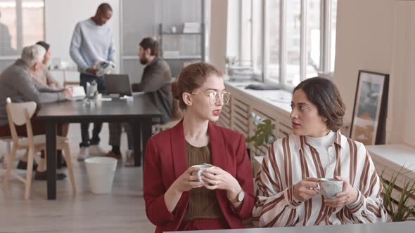 Office Friends Chatting Over Cup of Tea