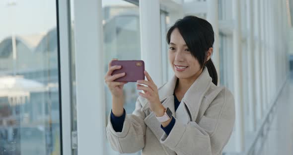 Woman Use of Mobile Phone to Take Photo in The Airport