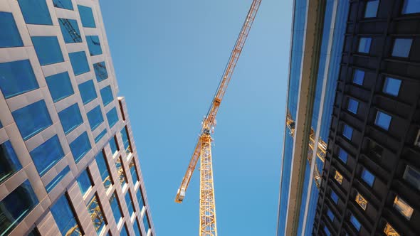 A Large Tower Crane in the Downtown of the Modern City