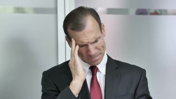Headache Portrait of Tense Middle Aged Businessman in Office