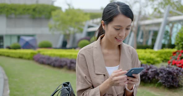 Woman use of mobile phone in the park