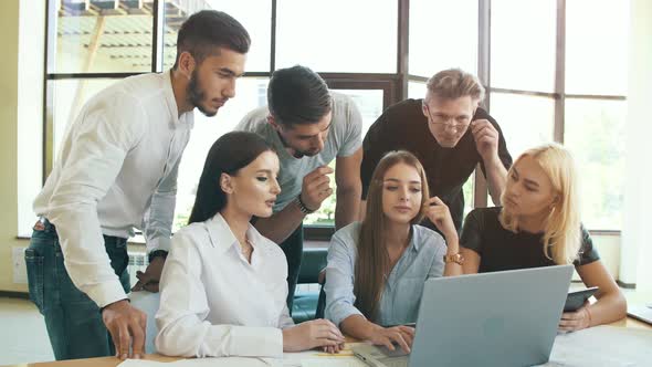 Group of Young Businessmen Working with Laptop Together
