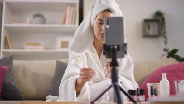 Woman Doing Manicure In Front Of Smartphone