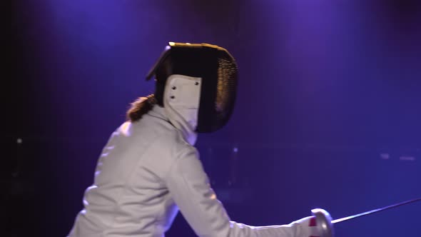 Two Female Athletes Practice Their Foil Skills at a Fencing Tournament