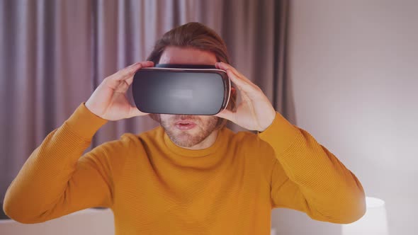 Young Caucasian Man Using VR Goggles