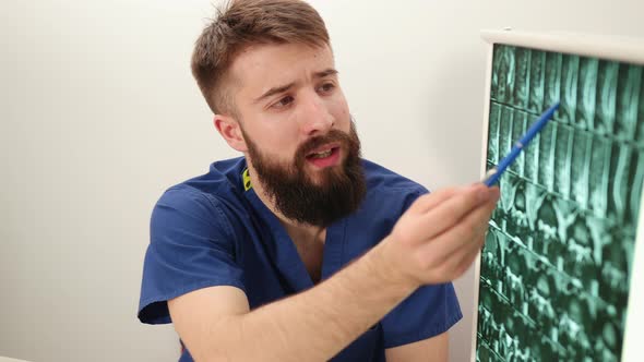 Physiotherapist Shows Patient an Xray Image of Skeleton of Bones