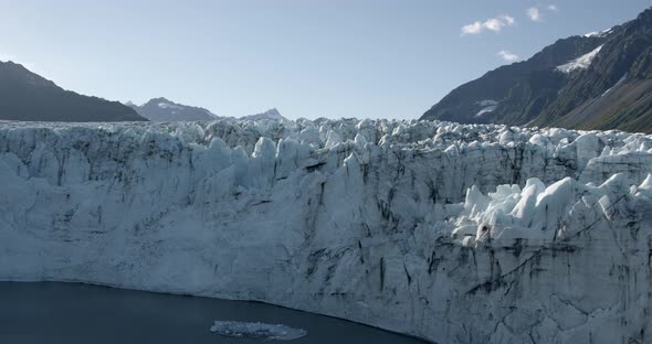 Helicopter Aerial View of Massive Glacier on Alaskan Coast on Sunny Day. Global Warming, Climate Cha