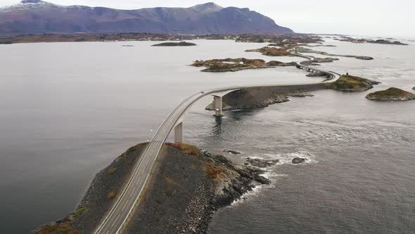 Car Driving Down On Storseisundet Bridge At Atlanterhavsveien In Norway. - aerial