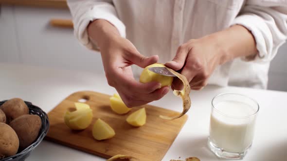 Cook White Girl Peeling Potatoes For Cooking Vegetable Food Woman Preparing Milk From Potatoes