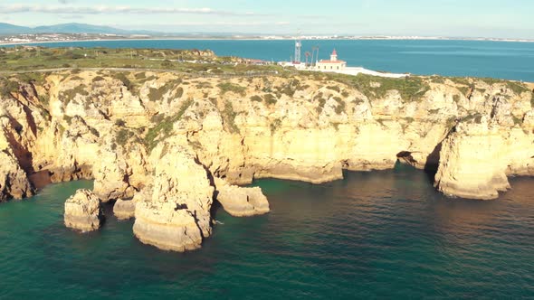 Ponta da Piedade limestone coastline and lighthouse over clifftop, Lagos, Algarve