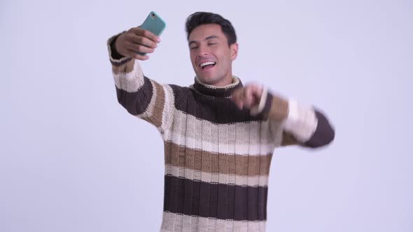 Young Happy Hispanic Man Taking Selfie Ready for Winter