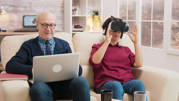 Amazed Senior Woman While Using Virtual Reality Goggles