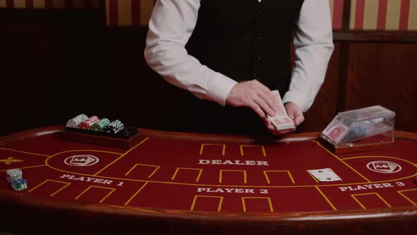 Slow motion footage of a casino dealer carefully placing cards at a poker table