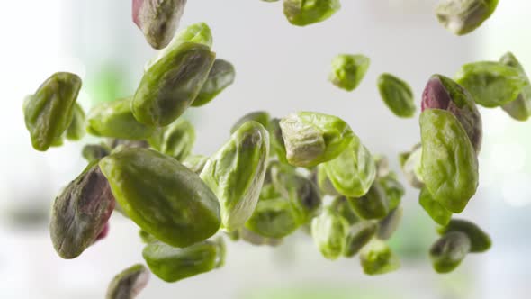 Flying of Peeled Pistachios in Kitchen Background