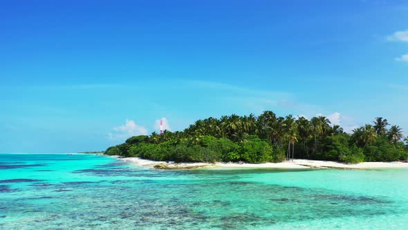 Natural fly over clean view of a sandy white paradise beach and aqua turquoise water background in c