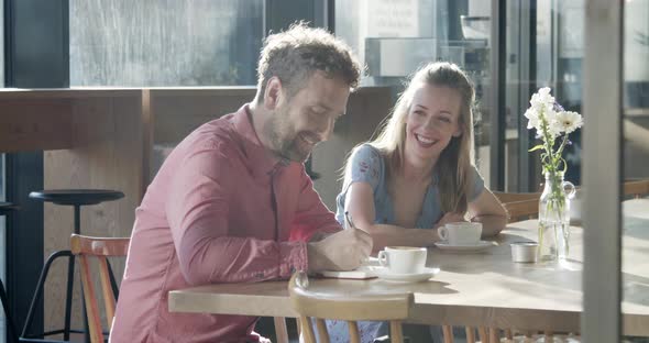 Two business partners having a meeting at a cafe