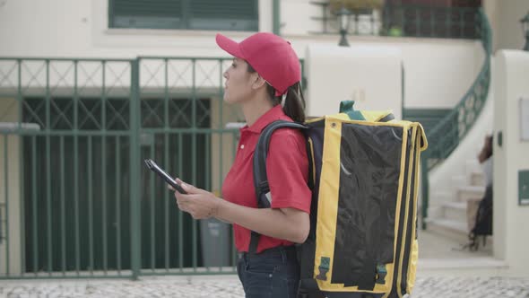 Courier Girl with Isothermal Backpack Consulting Tablet