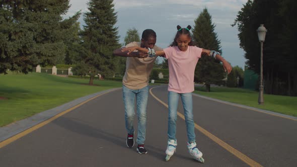 Black Teenage Girl Learning Roller Skating in Park