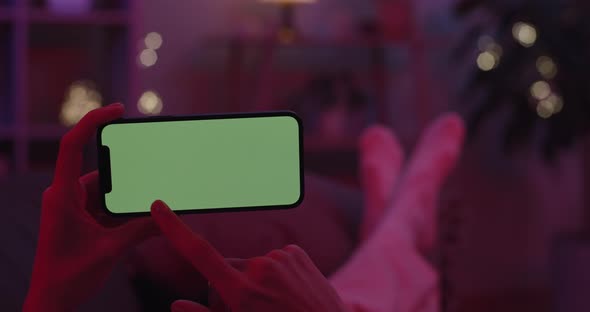 Woman Tapping on Green Screen of Modern Smartphone