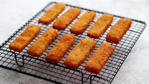 Rows of Golden Fried Fresh Fish Fingers Fillets