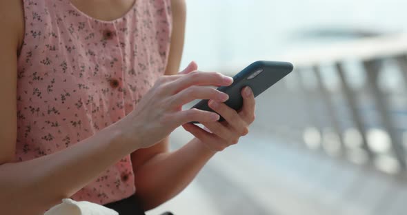 Woman hold with cellphone inside shopping center