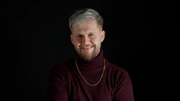 Smiling Cheerful Young Man in Trendy Stylish Clothes Holding Hands Crossed on Black Background