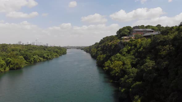 Rising shot of town lake in Austin TX, Shot slowly pans to reveal the cities downtown skyline in the