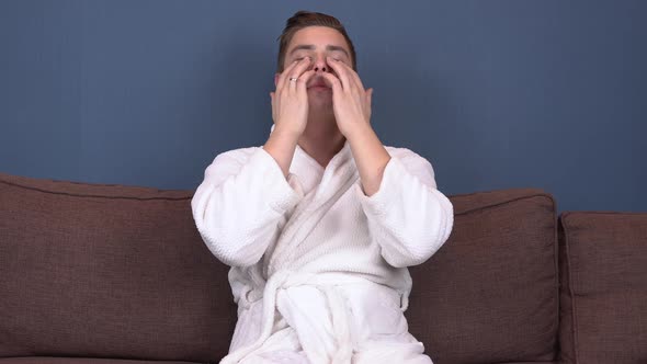 A Young Man with Patches on His Face Relaxes. Spa Treatments. Blue Hydrogel Patches for Facial