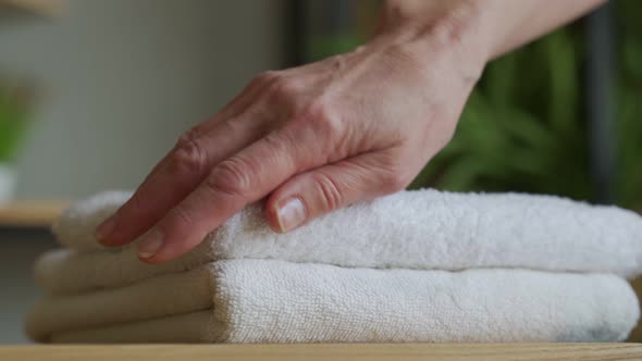 Old Woman Touches a Fresh White Towel