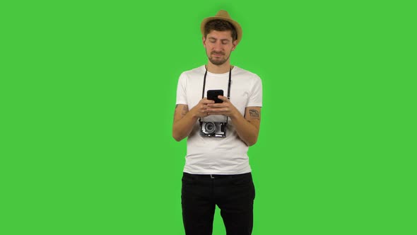 Confident Guy Is Texting on His Phone. Green Screen