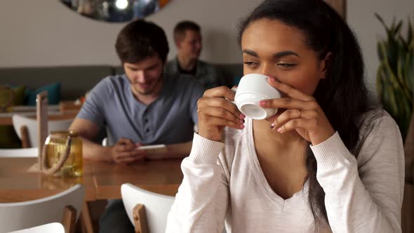 Girl Dreams Over the Cup of Coffee at the Cafe