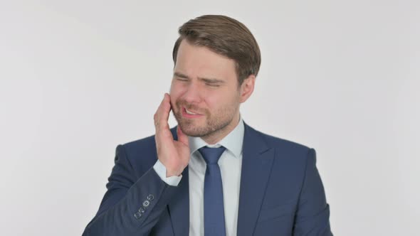 Young Businessman having Toothache on White Background