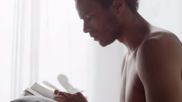 Man Reading Book after Waking Up