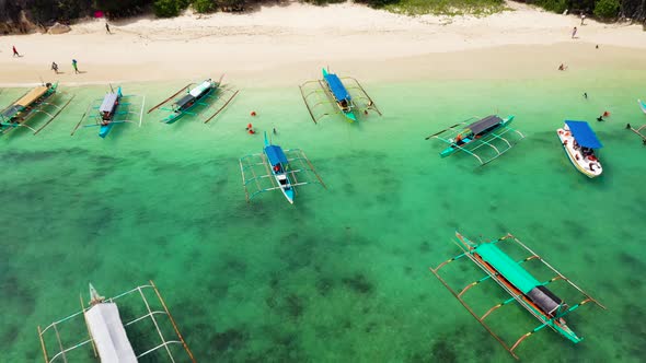 Caramoan Islands, Camarines Sur, Matukad. Philippines. Boats and Tourists on the Beach.