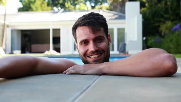 Portrait of young man relaxing in the pool