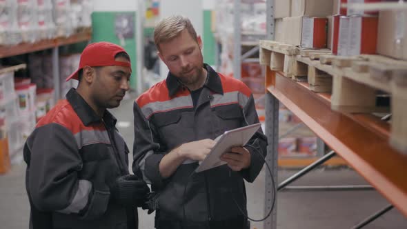 Workmen Scanning Barcodes At Warehouse