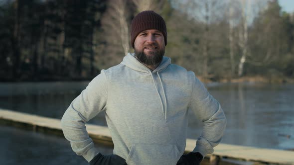 Portrait of caucasian man before swimming in frozen lake. Shot with RED helium camera in 8K.