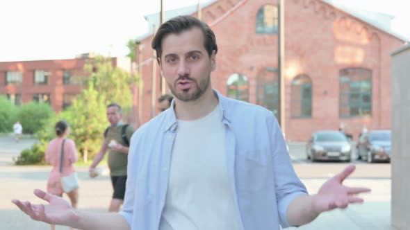 Man Talking on Online Video Call While Walking in Street