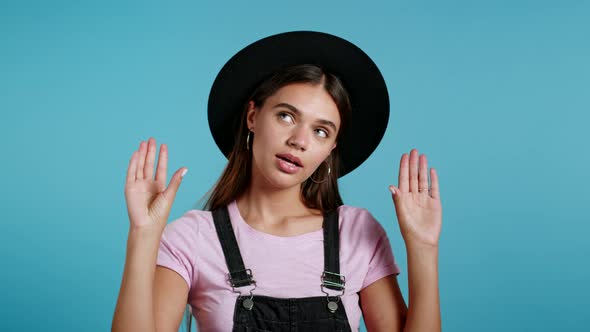 Hipster Bored Woman in Hat Showing Bla-bla-bla Gesture with Hands and Rolling Eyes Isolated on