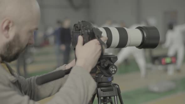 A Photographer (Cameraman) Shoots for Fencing Competitions. Slow Motion. Kyiv