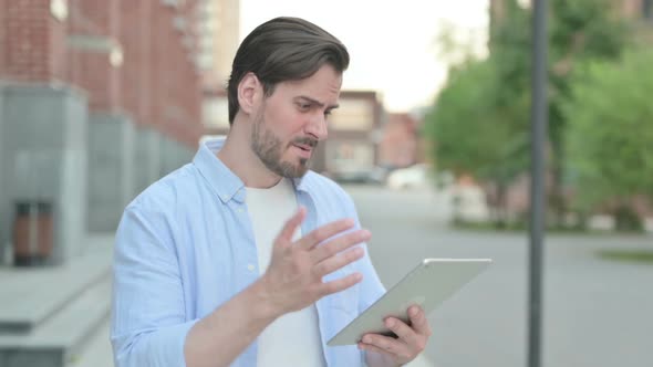 Portrait of Man Having Loss on Tablet Outdoor
