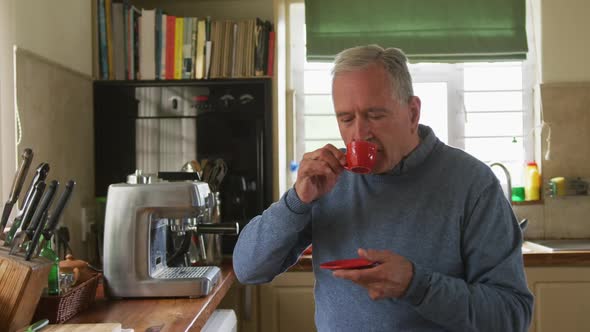 Senior man drinking coffee at home