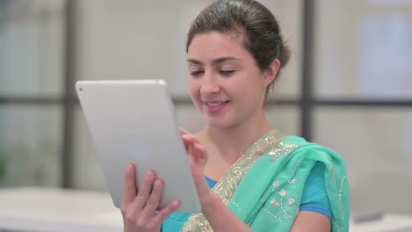 Portrait of Attractive Indian Woman Using Tablet in Office