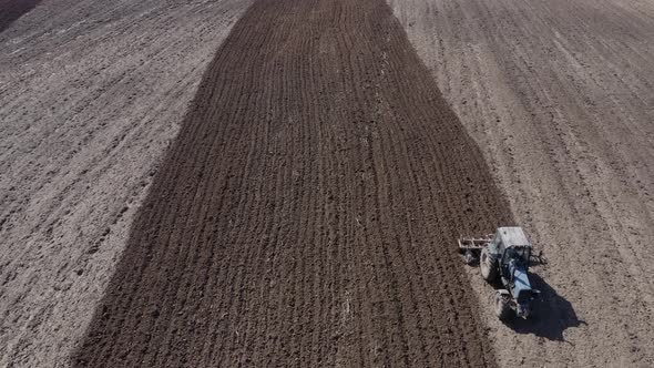 Aerial View of a Tractor That Plows the Land for Sowing