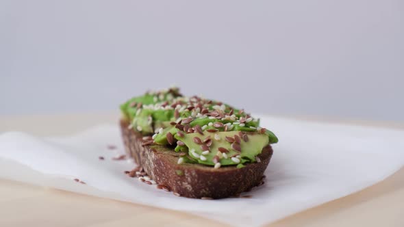 Healthy Avocado Toast Rotating on Wooden Board